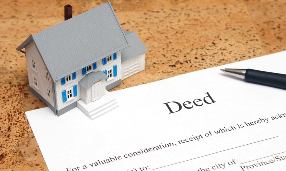 UAE Land Department transferring property title deed to the new owner